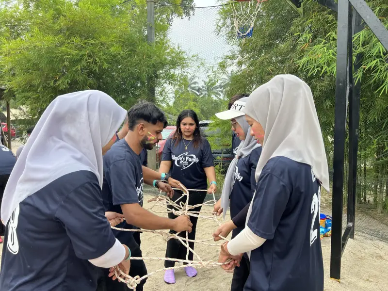 Team collaborating in a colourful outdoor coordination challenge